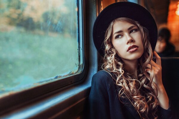 Beautiful girl in a hat and in the subway