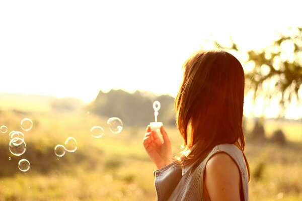 The girl blowing soap bubbles