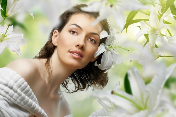 Portrait of a beautiful girl on a background of lilies