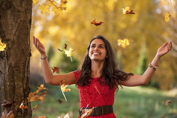 Beautiful girl playing with leaves