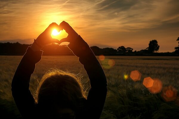 Little girl shows a heart for mom