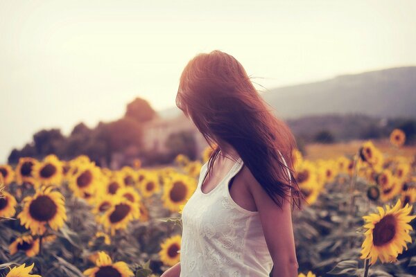 A girl in a field of yellow sunflowers