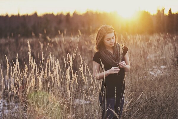 A girl in a field on the background of a schakat