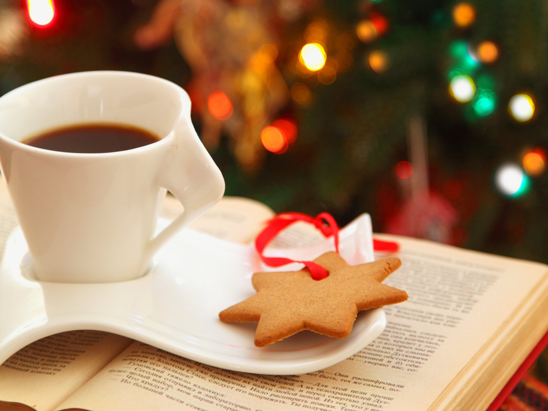 cup saucer tea coffee cookies an asterisk star book lights bokeh