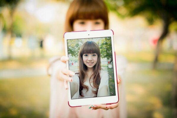 Orientale ragazza con Tablet Stand