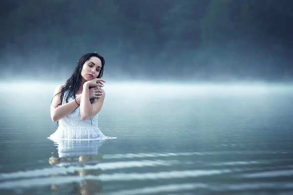 Photo of a girl in a foggy lake