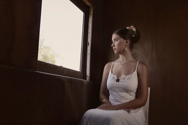 Thoughtful bride looks out the window