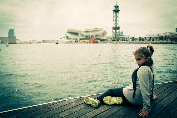 A girl on the dock with a fixed gaze