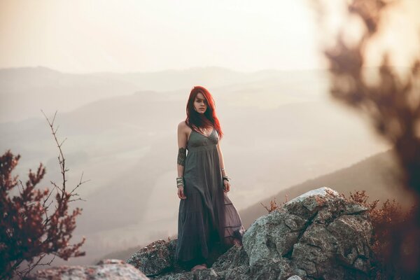 Red-haired girl on the rocks