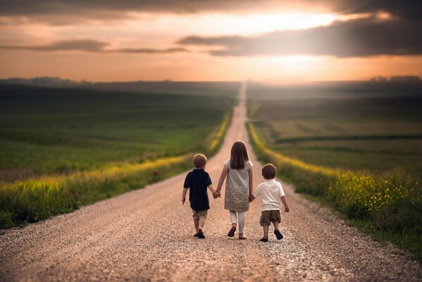 Children walk along the road to the field