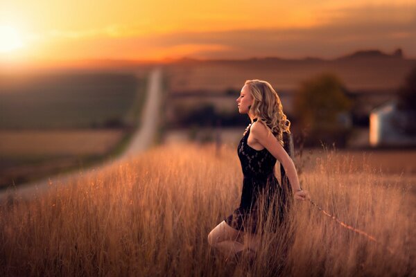 Girl in the field with a leash