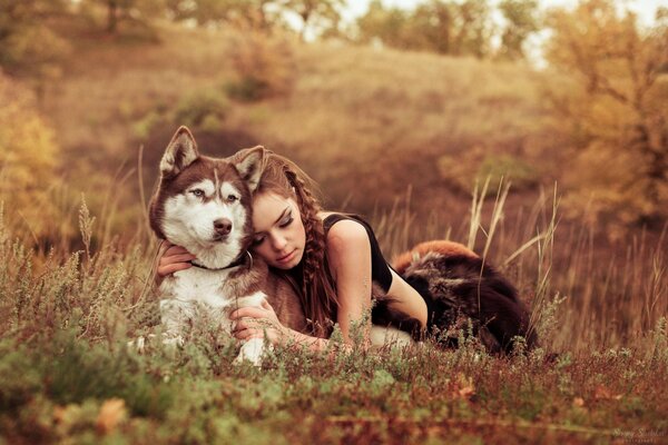 A girl and a husky dog enjoy nature