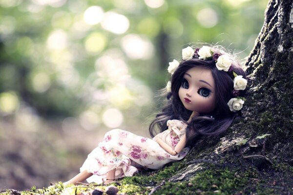 A doll in a beautiful wreath near a tree