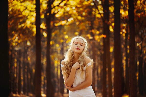 A girl on the background of an autumn forest