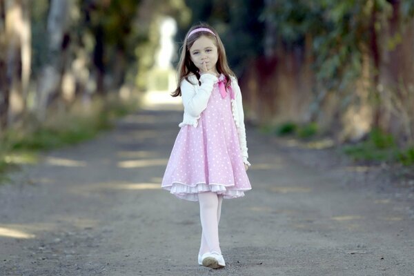 Cute girl in a pink dress