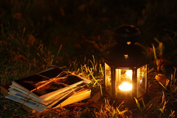 CANDLE ON THE GRASS WITH LETTERS