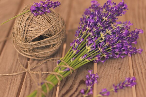 A bouquet of lavender with a ball of thread