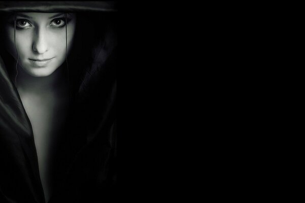 A girl portraying a vampire on a black background