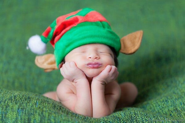 Newborns in a green hat with ears