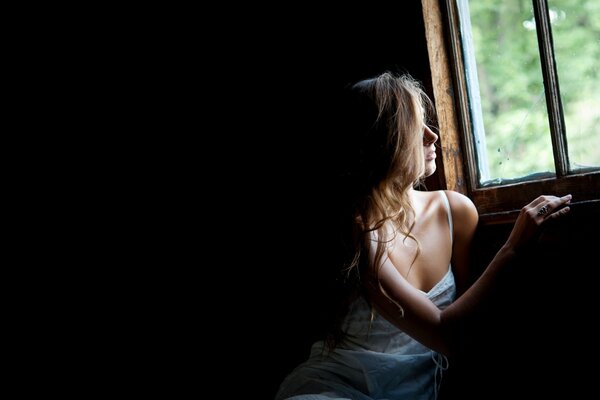 Cute girl looks out the window