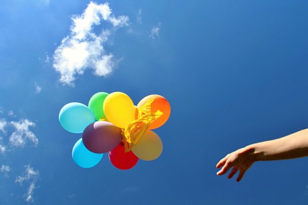 The hand releases the colored balls