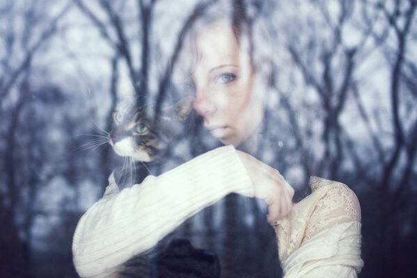 PENSIVE WITH A CAT BY THE WINDOW