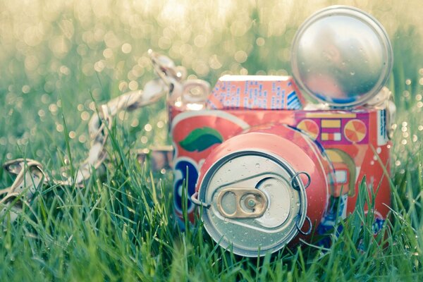 Creative tin can on a background of greenery