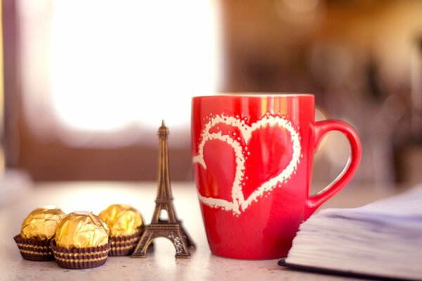 A mug with the Eiffel Tower and sweets