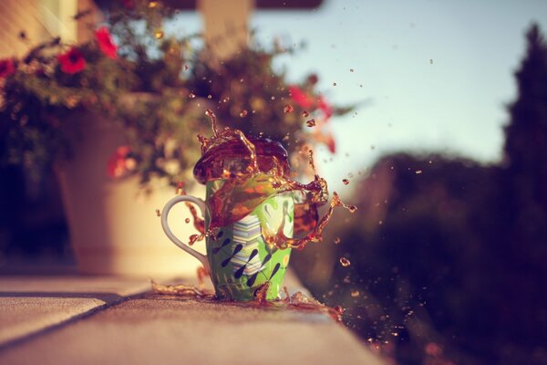 Splashes of tea from a mug on a blurry background