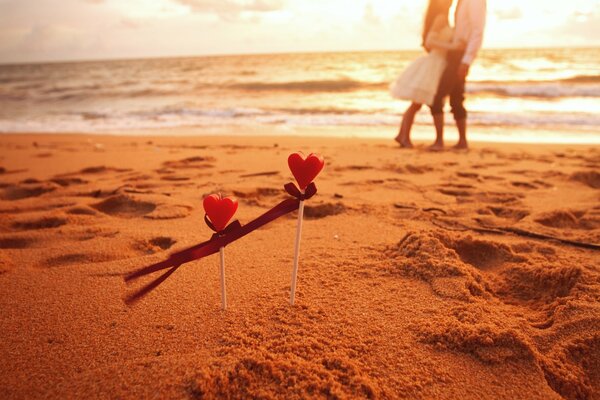 Two hearts and a couple by the sea