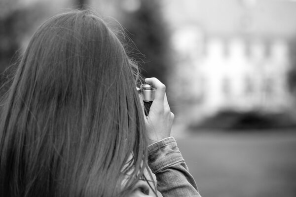 Long-haired girl with a camera wallpaper