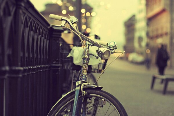 Bike at the fence on the city street