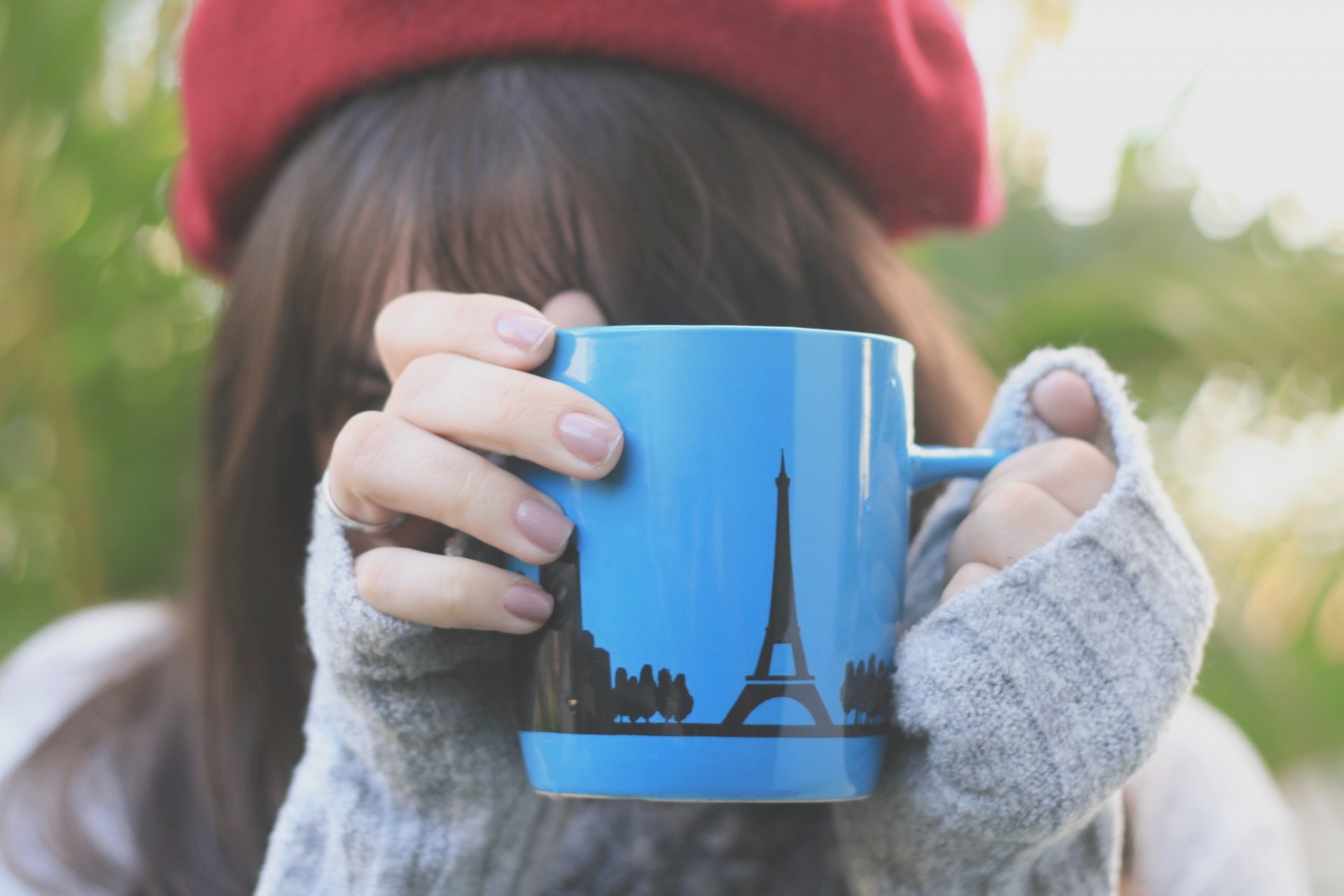 mood girl brunette hat red cup mug blue blue pattern drawing eiffel tower hands fingers nails varnish macro jacket gray nature greenery background blur widescreen wallpaper fullscreen wallpaper