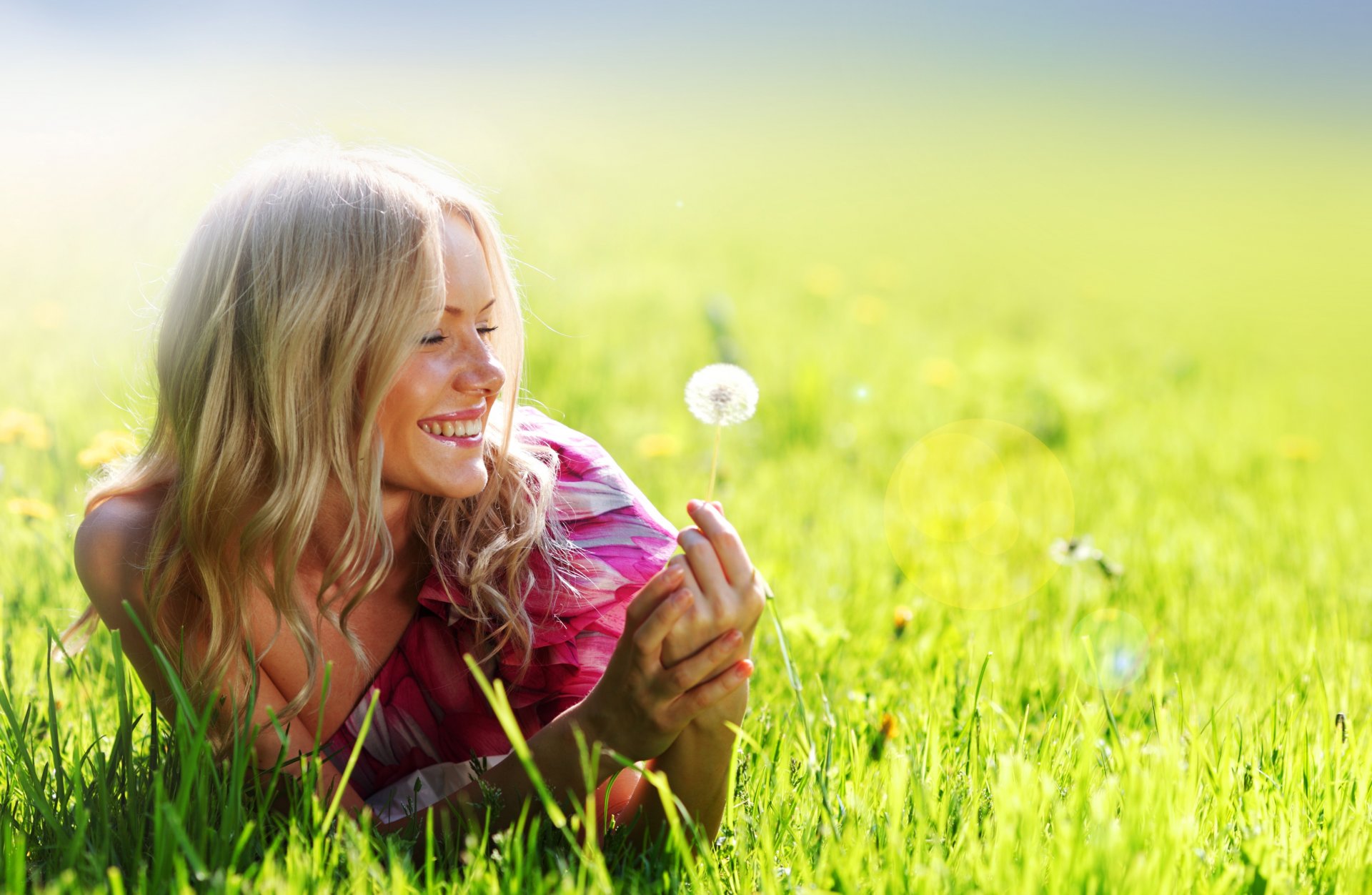 chica rubia sonrisa diente de león vestido rosa campo verano