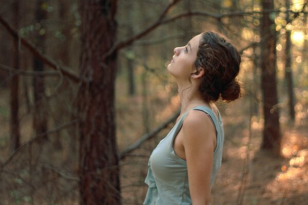 Pensive lady in the morning forest