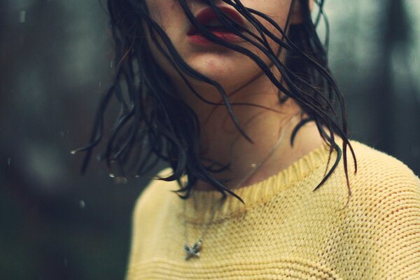 Wet hair in the rain girl in a yellow sweater