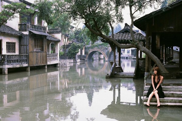 Fille en robe noire au milieu des inondations