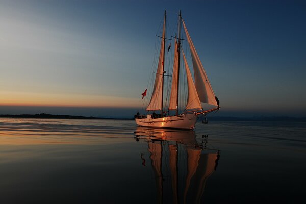 A sailboat in the night. Sailboat at sea during sunset