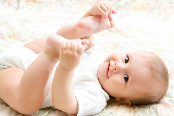 A beautiful baby smiles at the camera