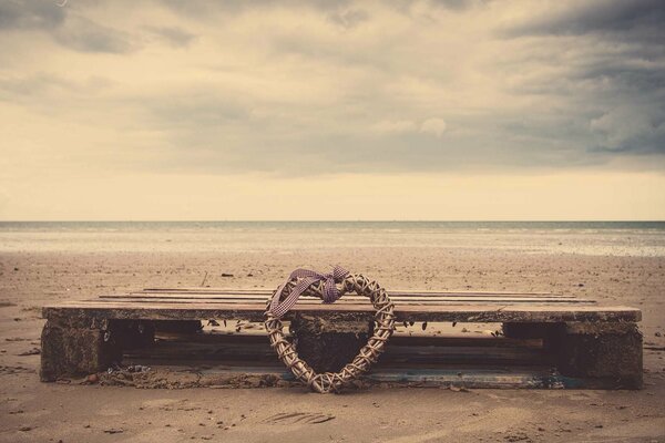 Un cœur oublié sur un banc au bord de la mer