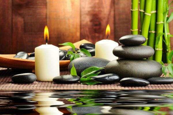 Bamboo, massage stones and burning candles