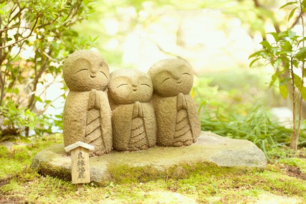 Three happy Buddhas in the forest
