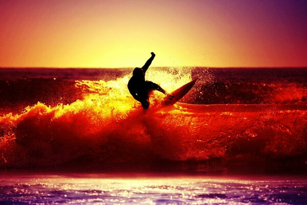 Surfer rides the scarlet waves