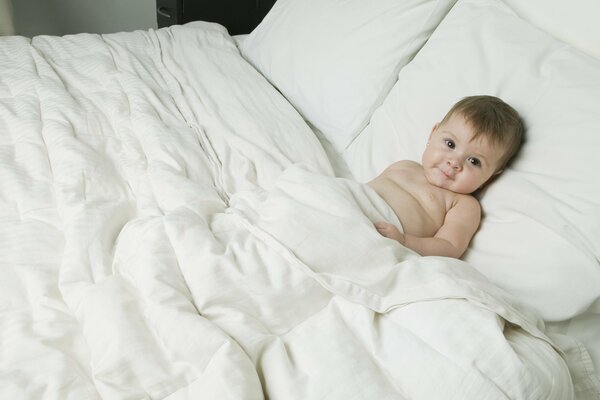 Cute baby in a soft bed