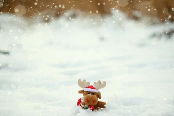 Cerf jouet dans un chapeau dans la neige