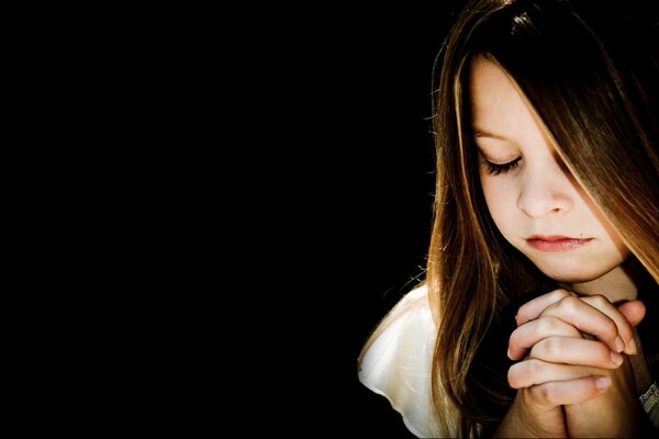 The girl folded her hands in prayer