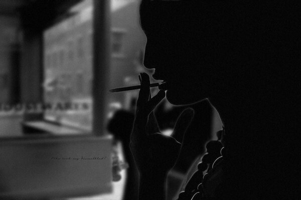 A girl with a cigarette on a dark background