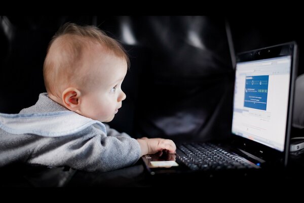 A small child in front of a laptop