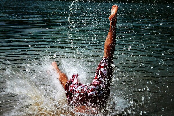 Jump into the water. Falling into the water and splashing sea