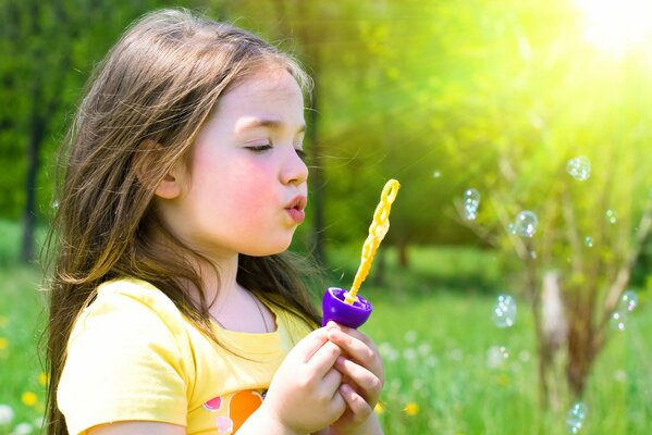 Happy girl with soap bubbles